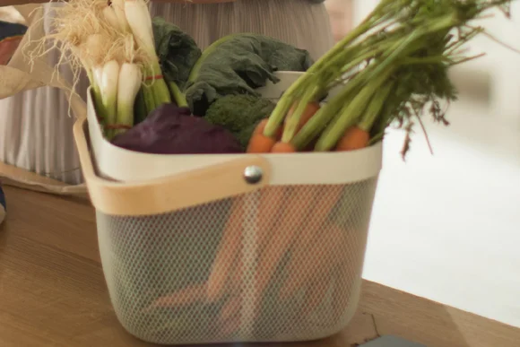 Gemüsekorb mit Karotten und Frühlingszwiebeln